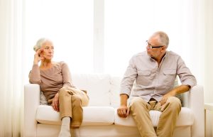 Man and woman sitting on couch looking at each other