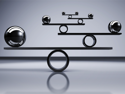 balance concept with balanced metal balls on grey background