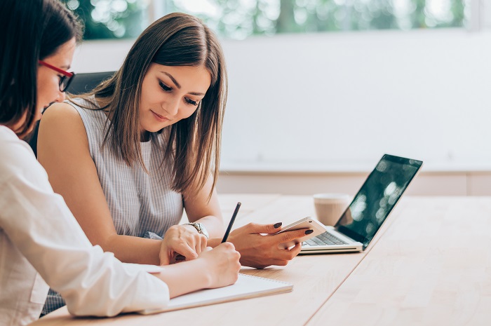 Two female colleagues in office working together