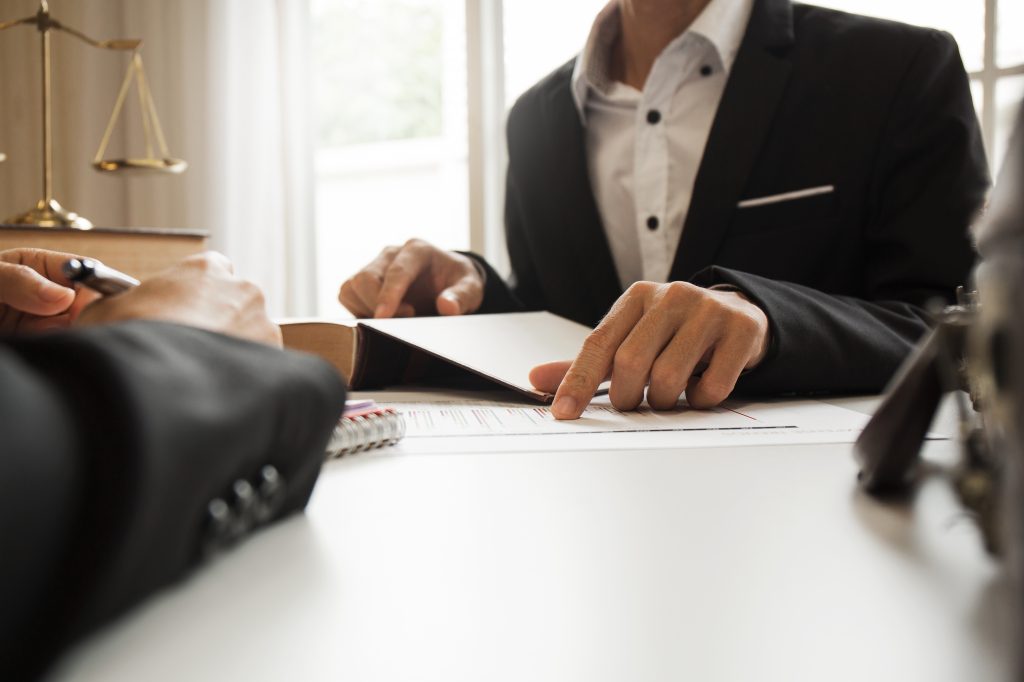 Business man in a meeting pointing at paper