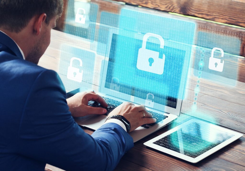 Man on computer with security locks on screens