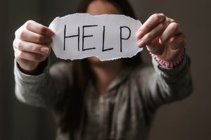 Person holding Help sign