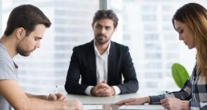 Man and woman reading documents in office