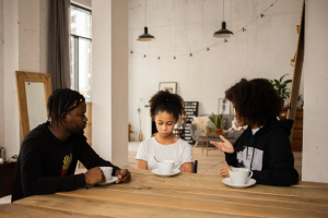 Parents sitting at table with upset child