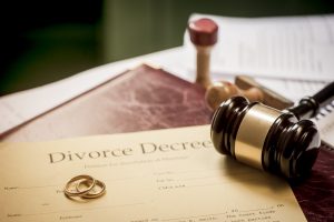 Divorce decree with rings and gavel