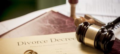 Divorce decree with rings and gavel