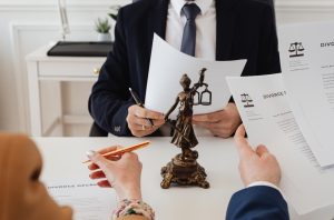 Signing divorce documents at desk