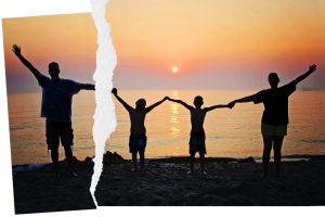 Family ripped picture of family holding hands at sunset 