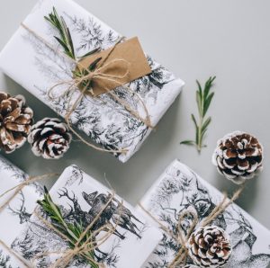 White wrapped gifts and pinecones