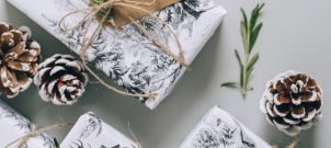 White wrapped gifts and pinecones