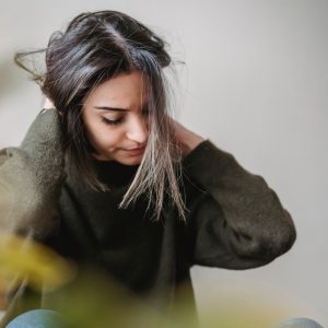 Woman with hands on back of neck