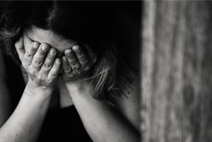 Woman with hands covering her face