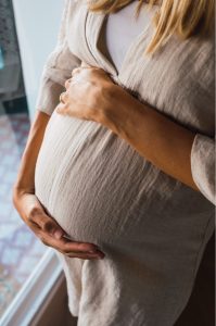 Pregnant woman with hands on her belly