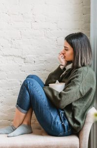 Woman sitting with box of tissues