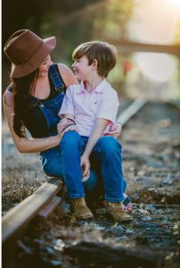 Woman with child sitting on her lap outside