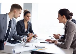 People sitting at a table with documents