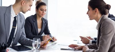 People sitting at a table with documents