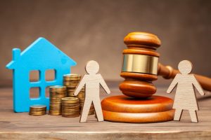 Gavel with coins and wooden cutouts