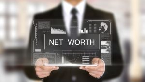 Man holding tablet with words "net worth"