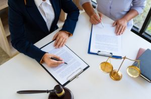 People at a table with documents and a gavel