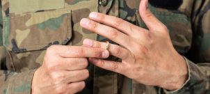 Man in military uniform removing ring