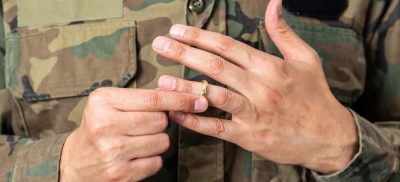 Man in military uniform removing ring