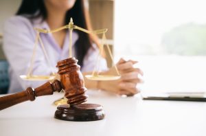 Woman sitting at a table with a gavel 