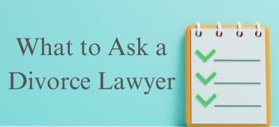 Notebook with check marks and text "What to ask a divorce lawyer"